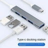 A silver Type-c docking station featuring four ports for simultaneous expansion and high-speed transmission.