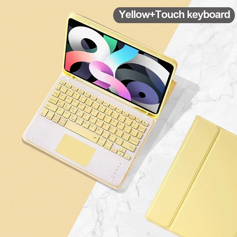 A yellow touch keyboard case for an iPad is shown on a marble surface.