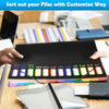 A close-up of black file folders with colorful tabs and monthly dividers being sorted on a wooden desk.