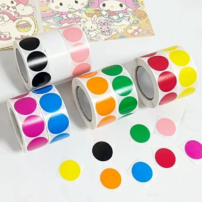 Rolls of round assorted color dot labels for organization showing various bright colors like pink, purple, yellow, and green.