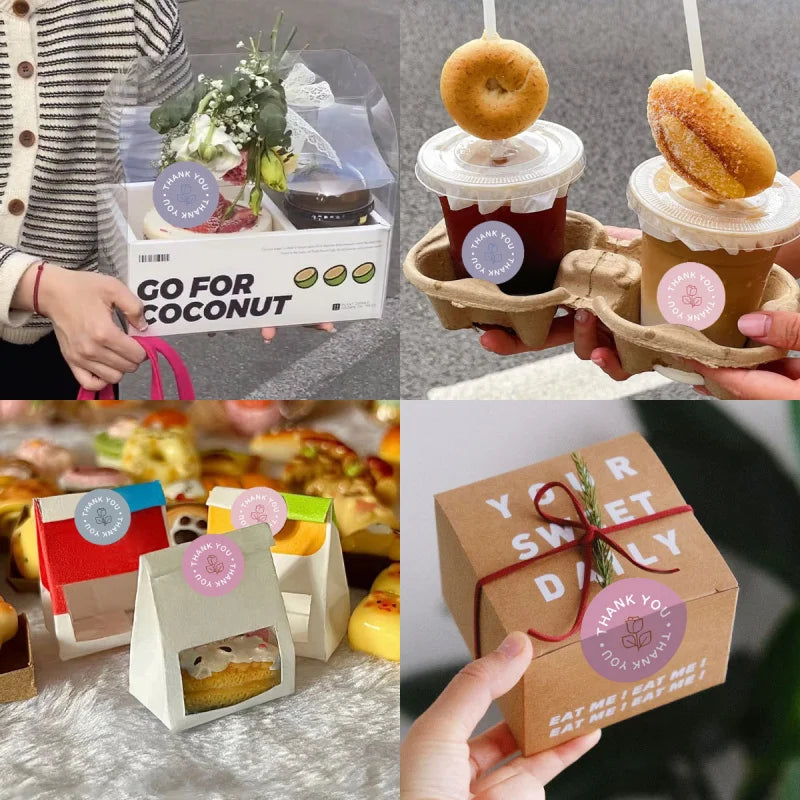 A hand holds a cardboard box of pastel rose thank you stickers roll.