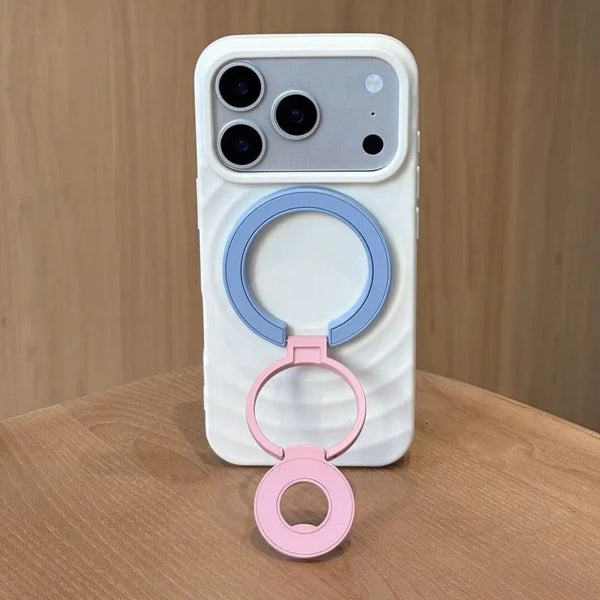 A white phone case with a magnetic ring grip featuring light blue and pink rings.