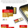 Sandisk Extreme memory cards in various capacities and formats shown next to a smartphone.