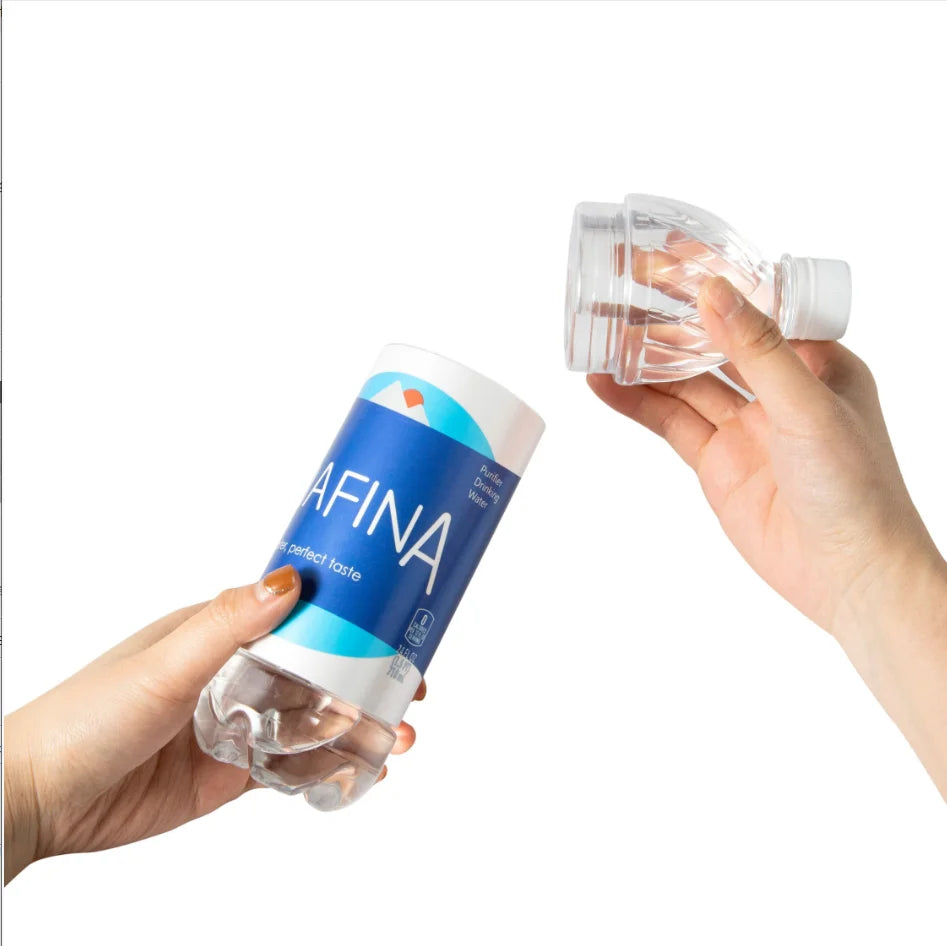 A hand holds a clear water bottle with a blue label and a clear plastic cup filled with water.