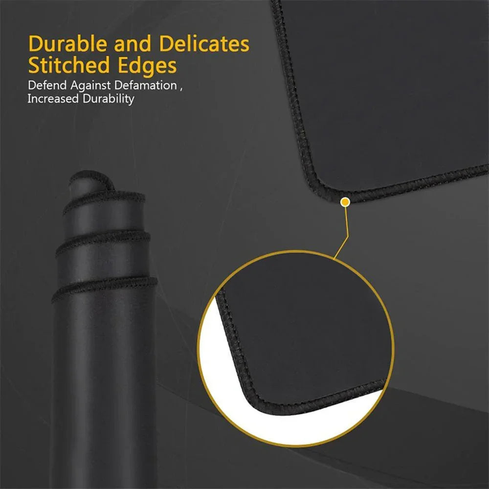 Close-up of a black desk mat with stitched edges, showing the durable and delicate construction.
