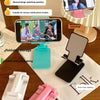 A multi-color foldable mobile phone holder shown with various folding and storage options on a wooden surface.