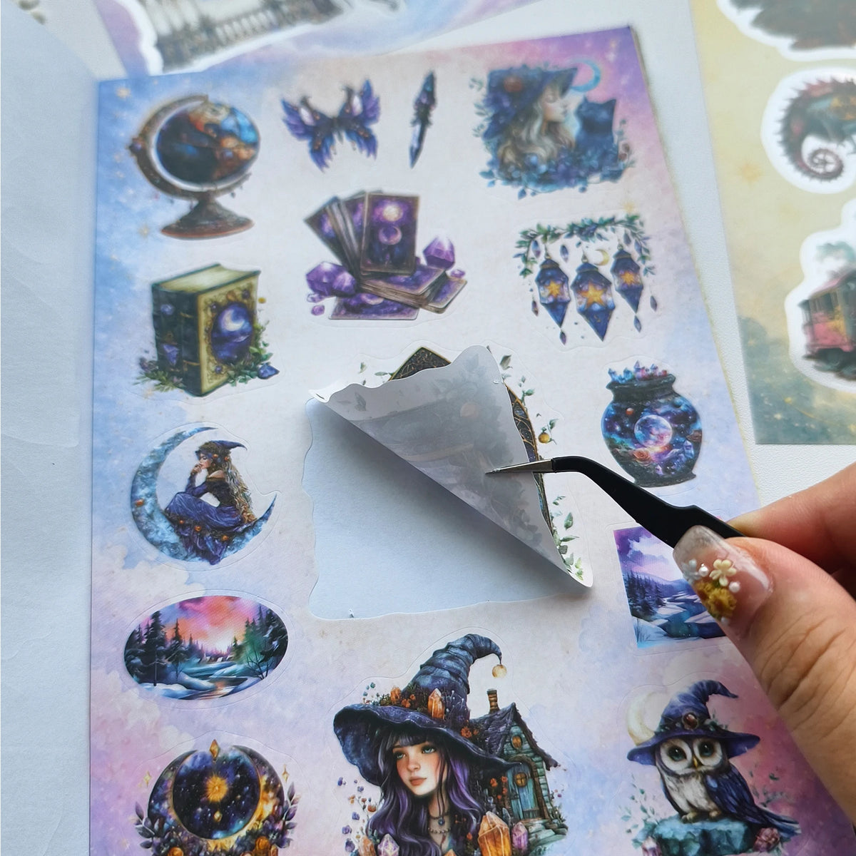 A page from a fantasy magic sticker book featuring illustrations of witches, magical objects, and mystical scenes.