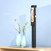 A black extendable phone tripod with an LED ring light and mirror standing on a wooden surface.