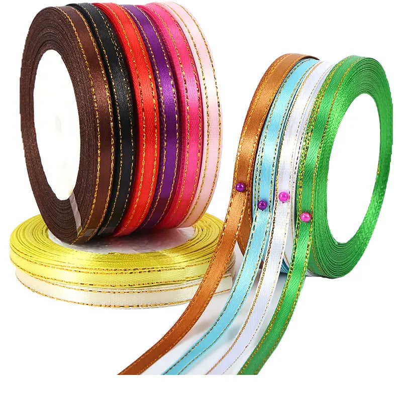 A collection of satin ribbons in various colors including red, orange, purple, and green, displayed on a spool.
