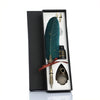 A black gift box contains a feather, a dip pen, and a dagger set for retro calligraphy.
