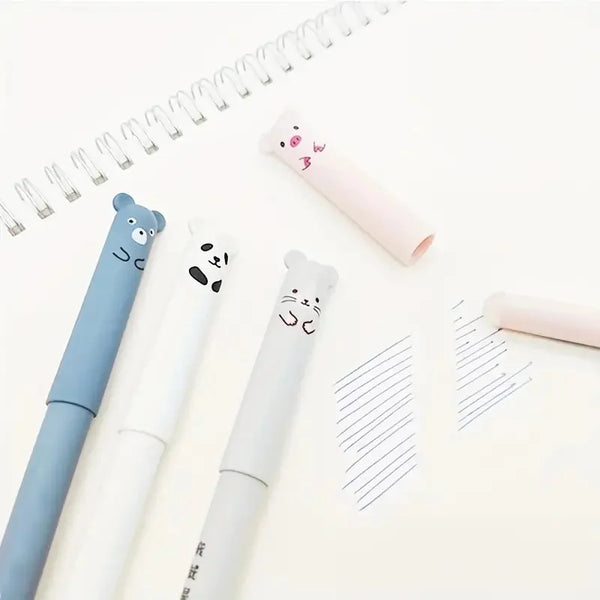 A set of pink and blue panda-themed erasable gel pens with refills placed on a white background next to a spiral notebook.