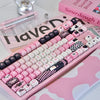 A pink and black PBT keycap set featuring various characters and designs for mechanical keyboards.