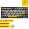 A black mechanical keyboard featuring a yellow keycap, RGB backlight, and a gift switch.