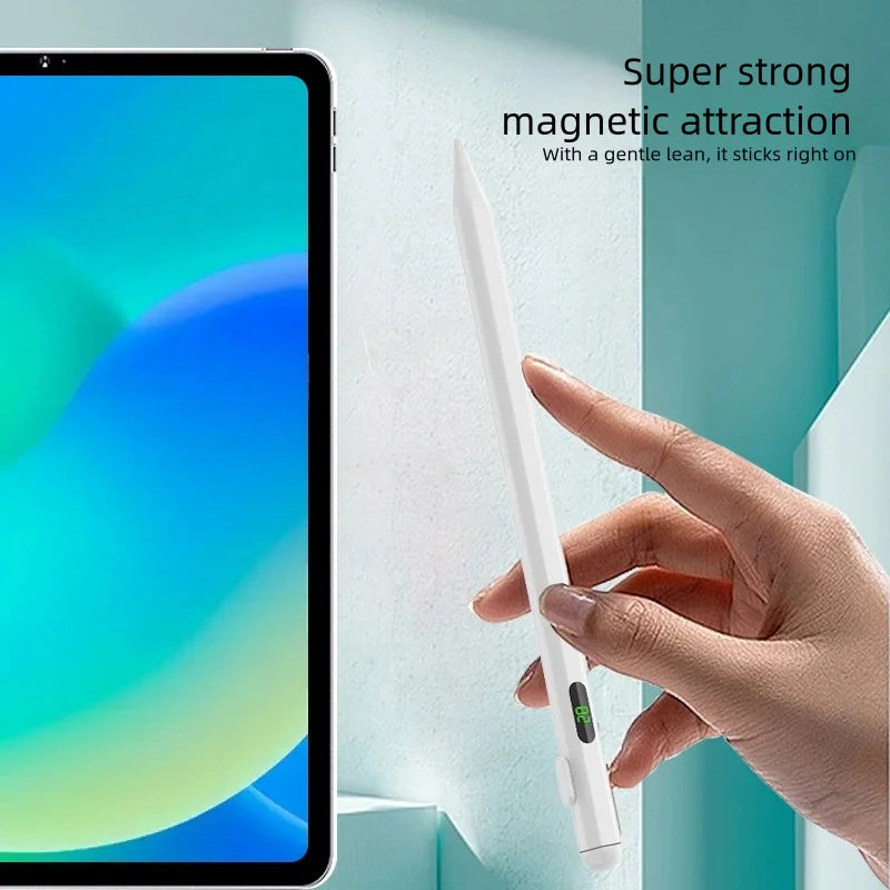A hand is using a white stylus pen to magnetically attach to a tablet screen.