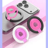 A pink magnetic ring grip with a foldable kickstand shown on a gray smartphone.
