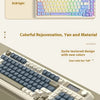 A close-up view of a light-colored mechanical keyboard with blue and gray keys, showing colorful RGB lighting.