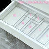 A clear acrylic drawer organizer set with seven compartments labeled XL, S, M, L, and others, displayed in a white organizer 