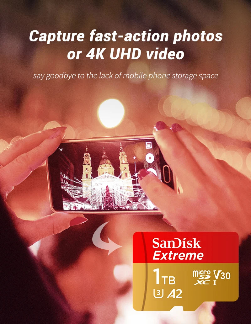 Hands hold a SanDisk Extreme microSDXC memory card, capturing a photo or video on a mobile phone.