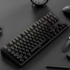 A close-up view of a black mechanical keyboard with purple keycaps and side printing on a dark surface.