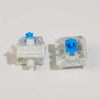 A clear plastic housing for mechanical keyboard switches and a keycap puller set with blue components.
