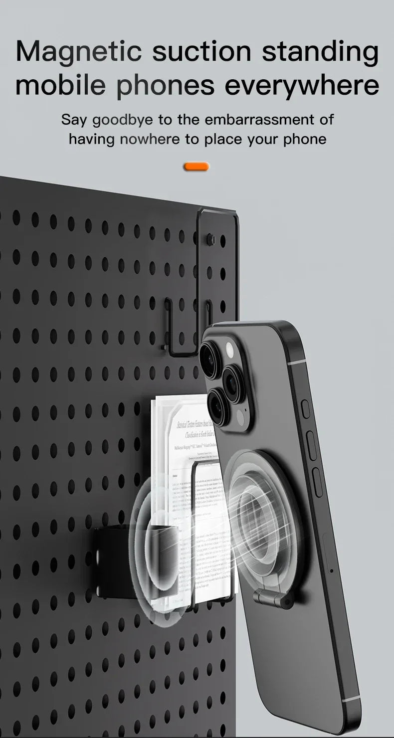 A black smartphone is magnetically suction-mounted onto a dark surface, demonstrating its use as a mobile phone stand.