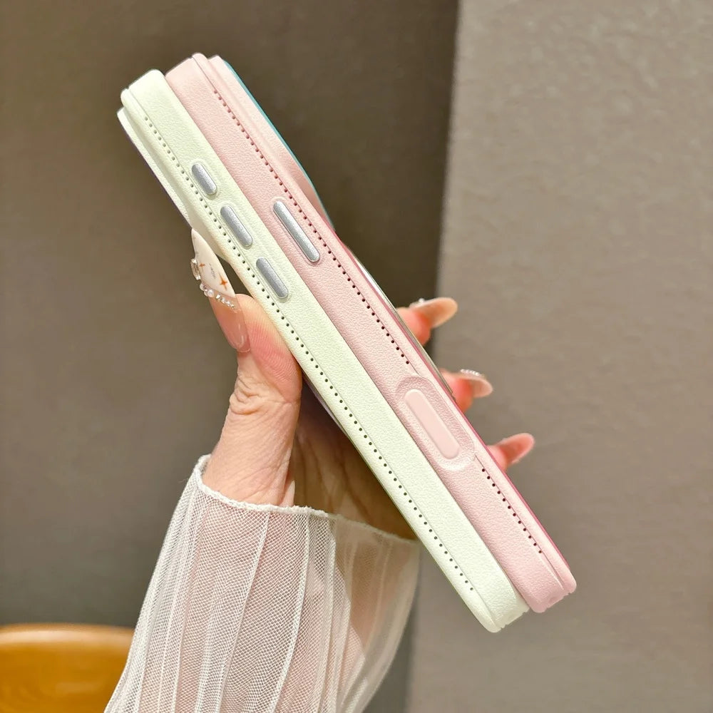A hand holds a pink and white magnetic ring stand shockproof phone case with camera protection.