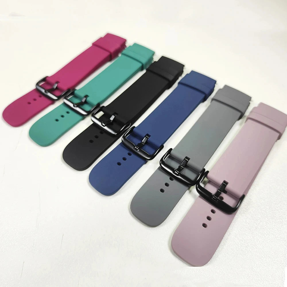 A collection of silicone watch bands in various colors including pink, teal, black, blue, and gray.