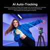 A young woman wearing a blue jacket smiles while demonstrating AI auto-tracking with a camera setup.
