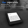 A close-up of a black Kindle Paperwhite ebook reader displaying text on a white background.