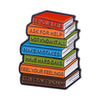 An enamel lapel pin shaped like a stack of seven books with motivational phrases on each one.