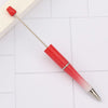 A red beadable pen with a silver tip is shown lying on a white surface.