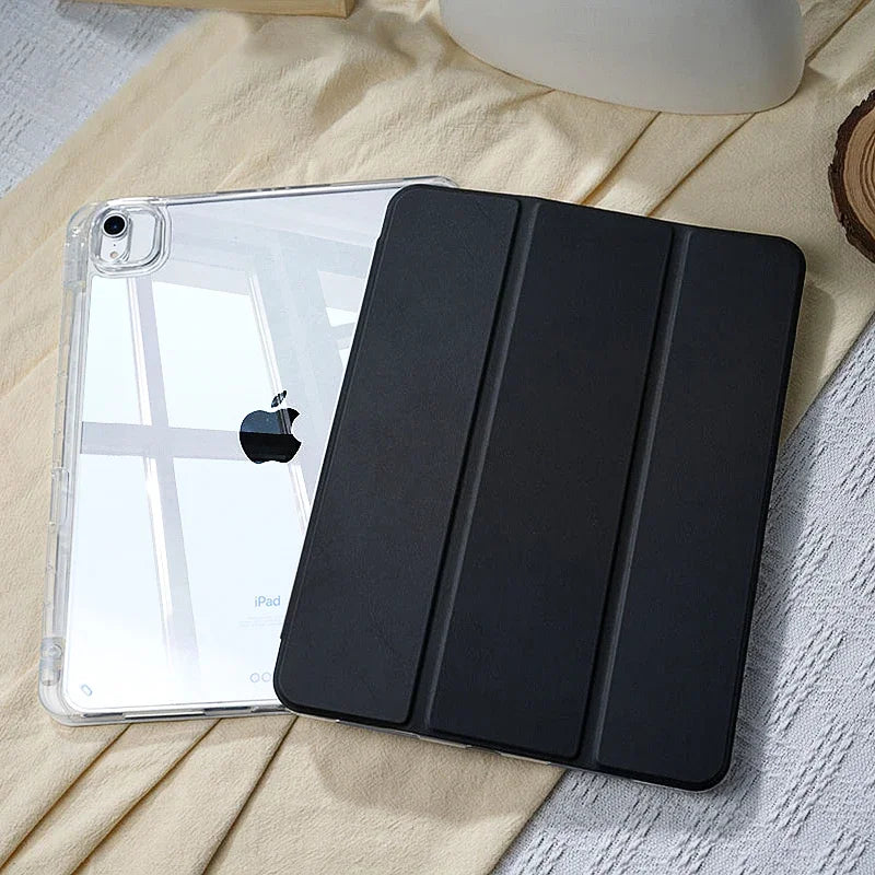 A black universal protective case for an Apple iPad lying on a light yellow fabric.