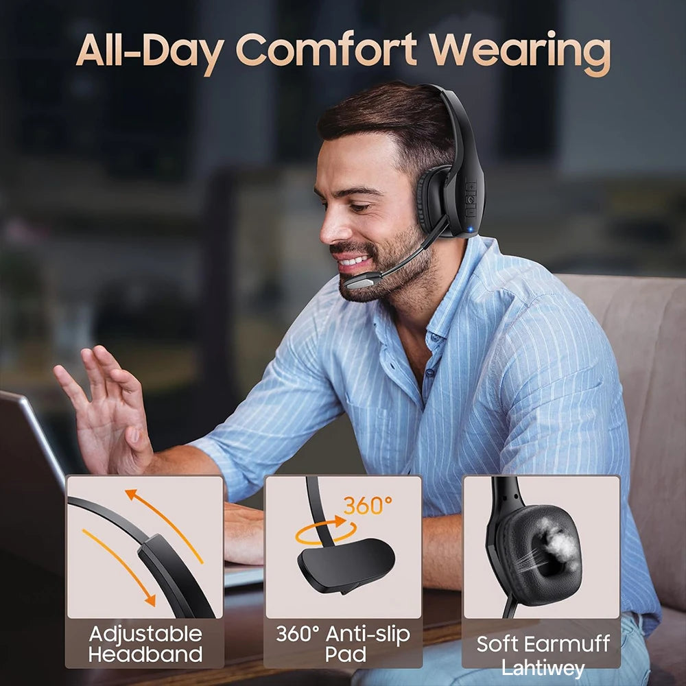 A man wearing a black Bluetooth headset for all-day comfort while working on a laptop.