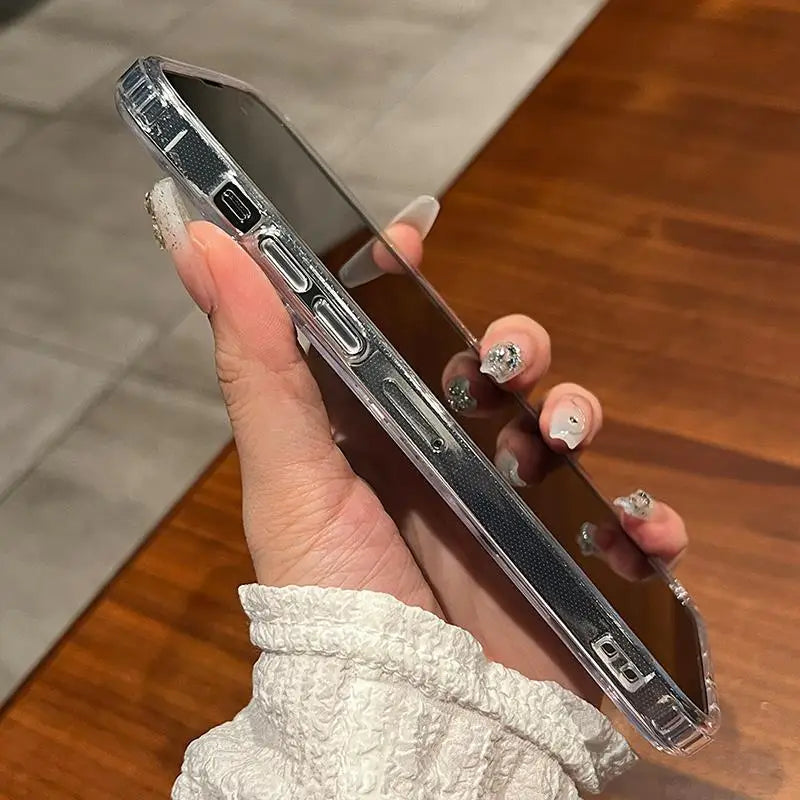 A hand holds a clear magnetic phone case with built-in magsafe compatibility against a wooden background.