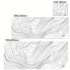 Abstract black and white wavy desk mat featuring subtle lines and a small white object.
