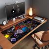 A dark mouse pad featuring various cartoon characters and designs placed on a wooden desk.