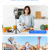 A woman is using a versatile selfie stick tripod to record a live video broadcast outdoors.