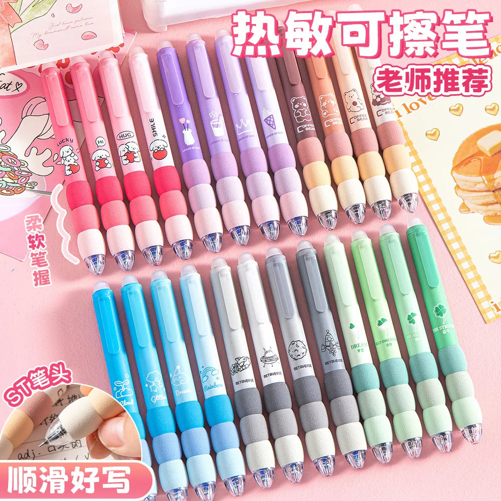 A collection of pastel-colored erasable gel pens with soft grips and black ink, displayed in a pink and white context.