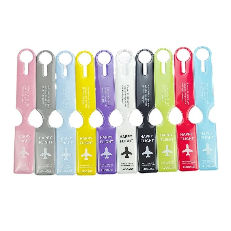 A row of colorful durable PVC luggage tags in various shades including pink, gray, blue, yellow, and green.
