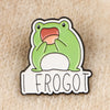 An enamel pin featuring a cartoon frog with an open mouth and the text FROGOT.