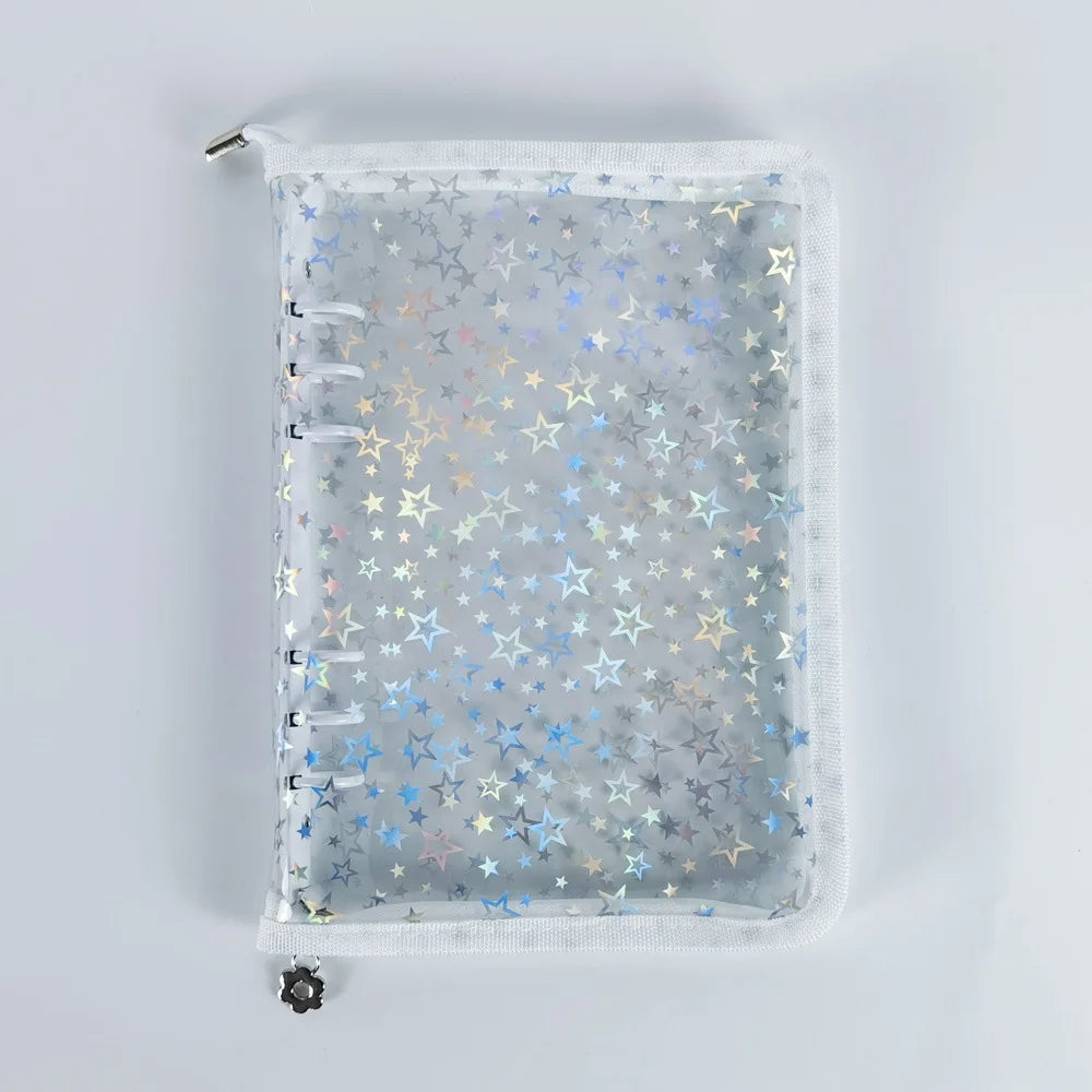A clear A5 sticker organizer binder with gray background and scattered gold and blue stars.