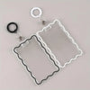 Clear acrylic card holder with a black wire frame and attached to a metal key ring.