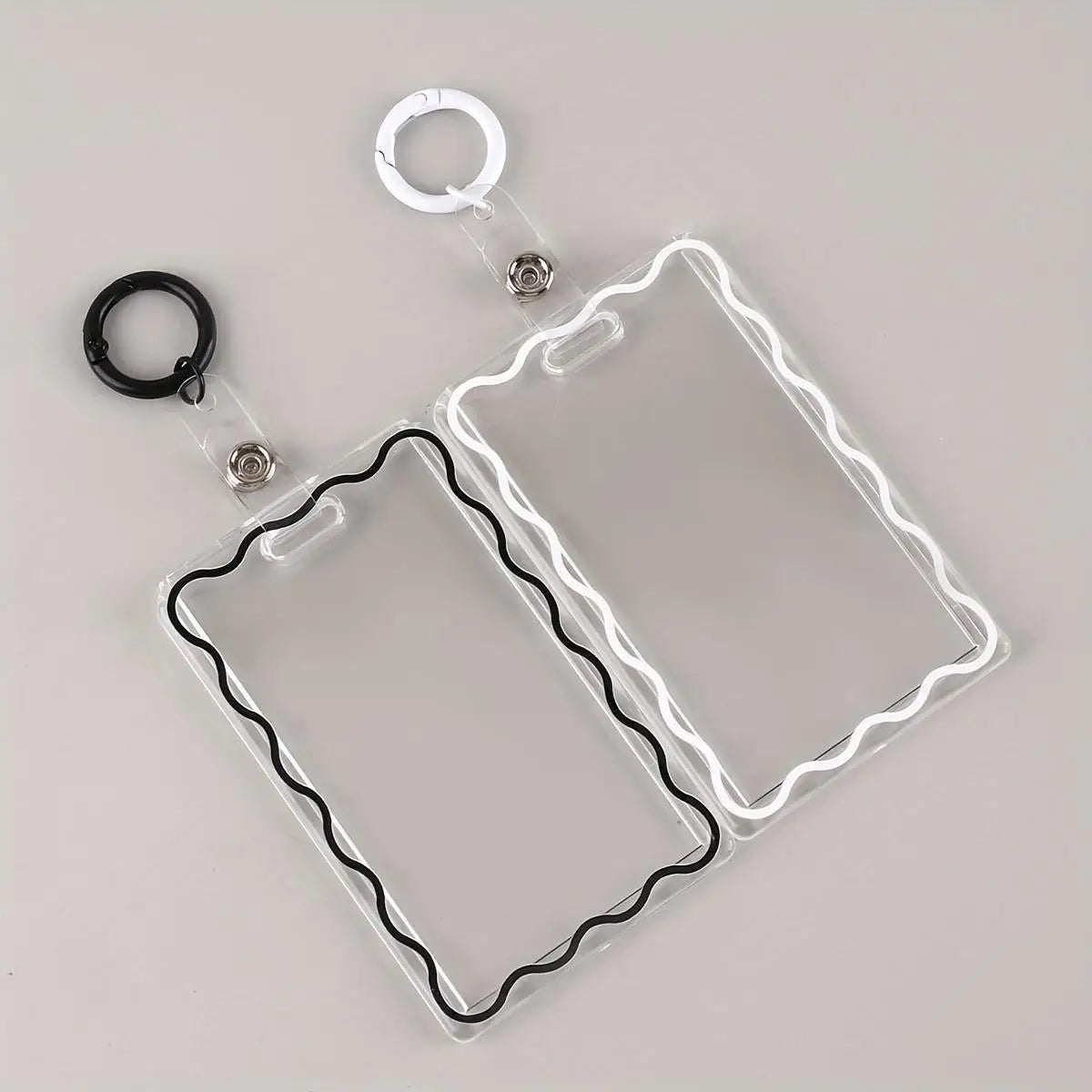 Clear acrylic card holder with a black wire frame and attached to a metal key ring.