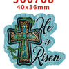 A teal water ripple acrylic hair bow set featuring a cross design with green foliage and the text He is Risen.