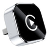 A silver adapter for a vehicle, featuring a black square with a white play button icon.