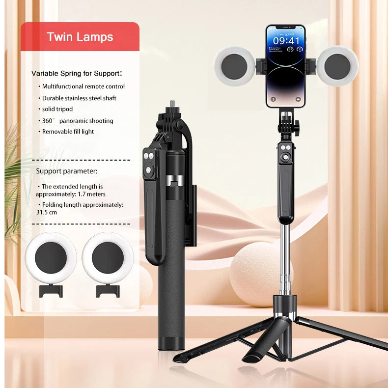 A black portable Bluetooth selfie stick tripod with two round lights and a smartphone mount is displayed on a wooden surface.