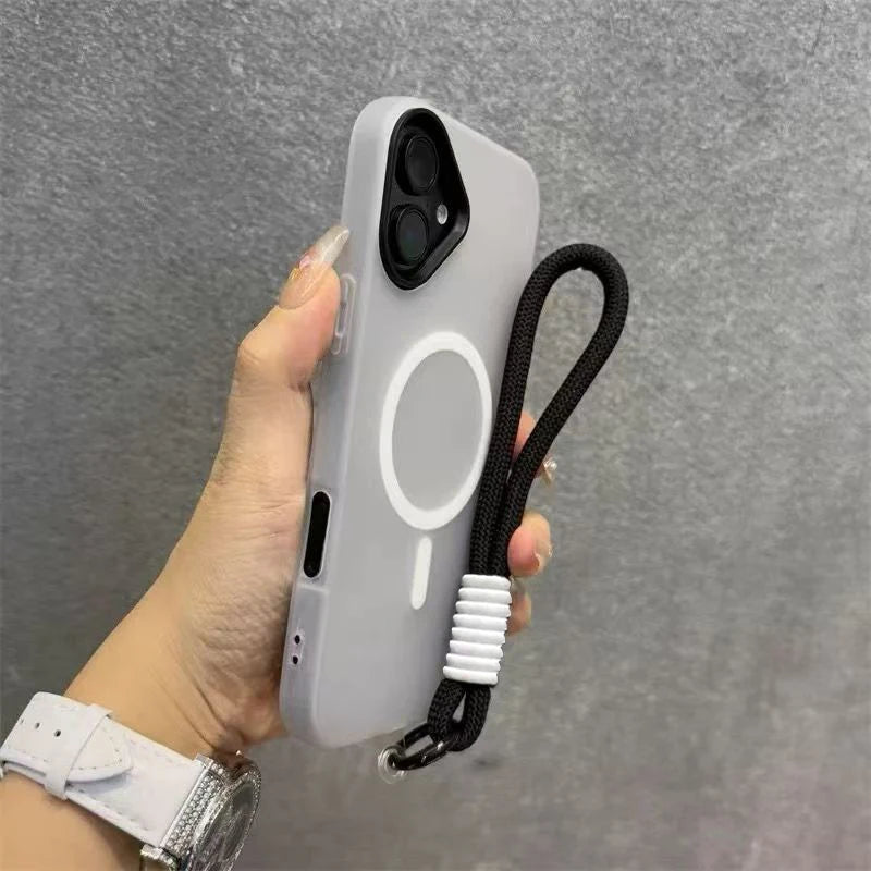 A hand holds a light gray phone case with a magnetic candy design and a black lanyard.