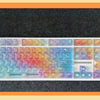 A full set of rainbow colored PC keycaps for a mechanical keyboard displayed on a dark surface.