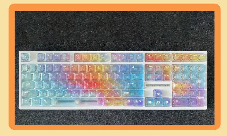 A full set of rainbow colored PC keycaps for a mechanical keyboard displayed on a dark surface.