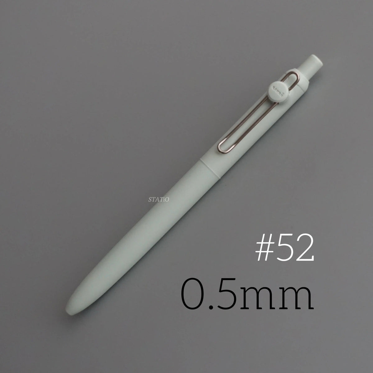 A light green precision gel pen with a silver clip and a pointed tip, shown diagonally on a gray background.